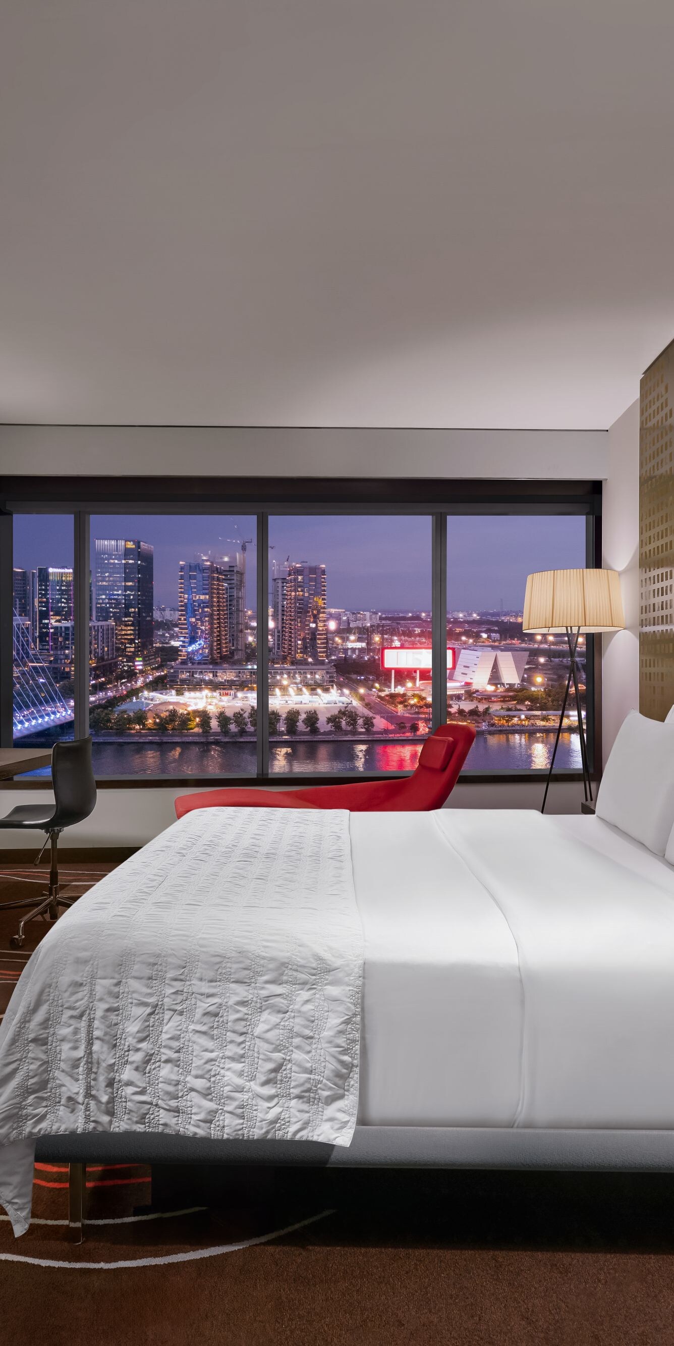 Spacious Premier Classic room at night with views