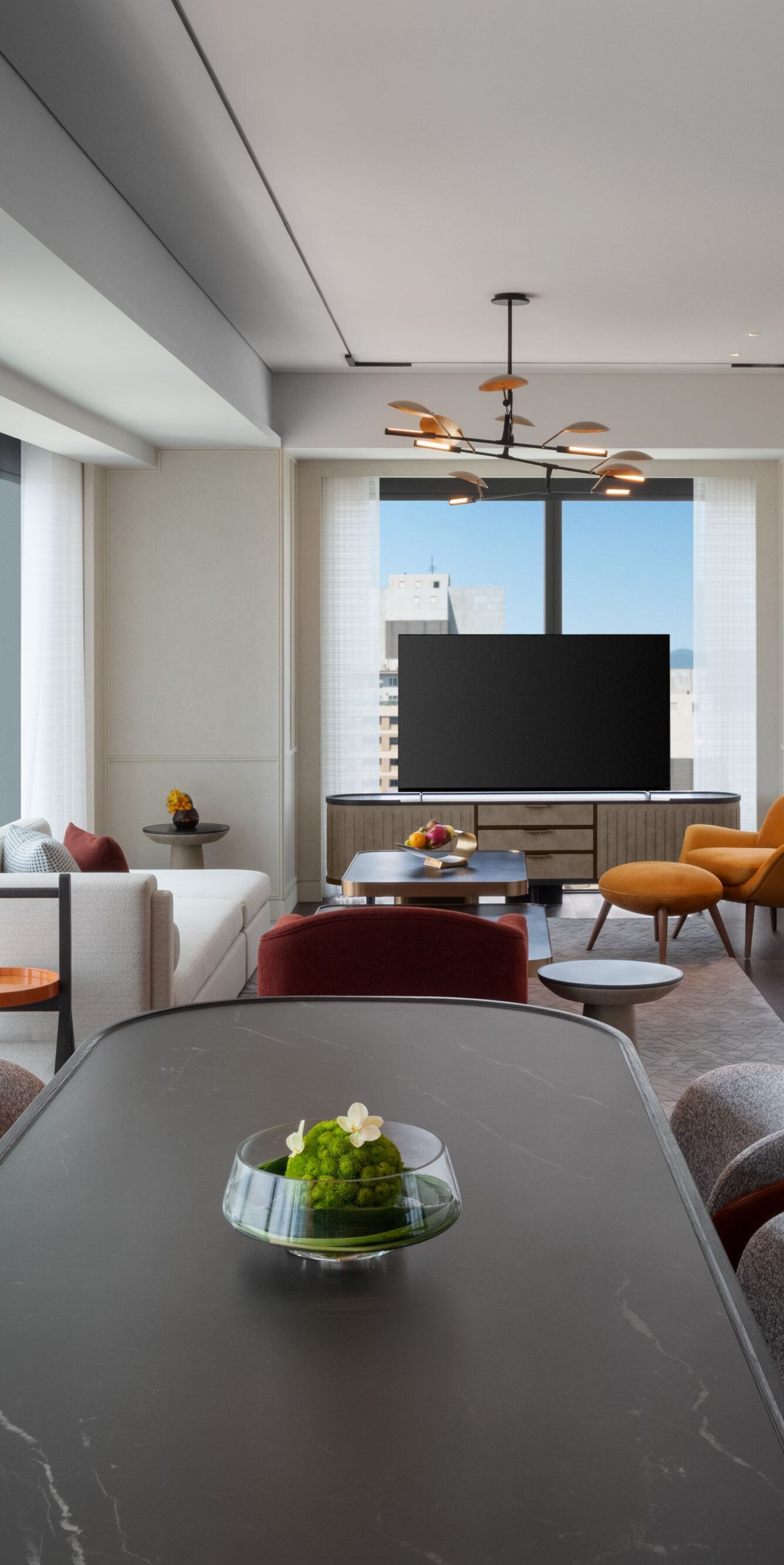 TV, dining table, sofa, open city views