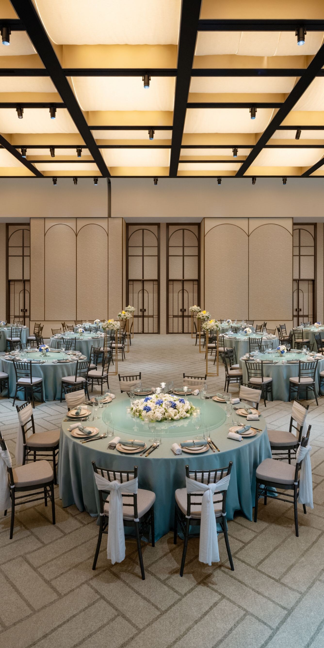 Naturally lit Grand Ballroom with elegant tables