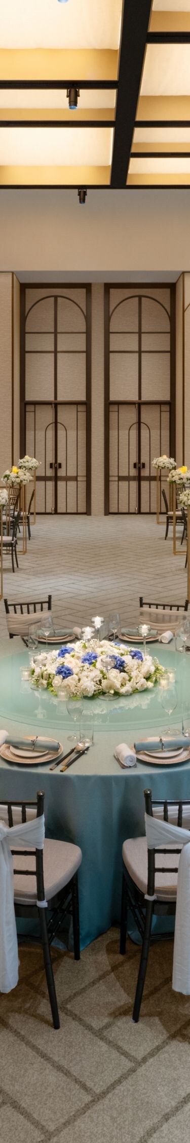 Naturally lit Grand Ballroom with elegant tables