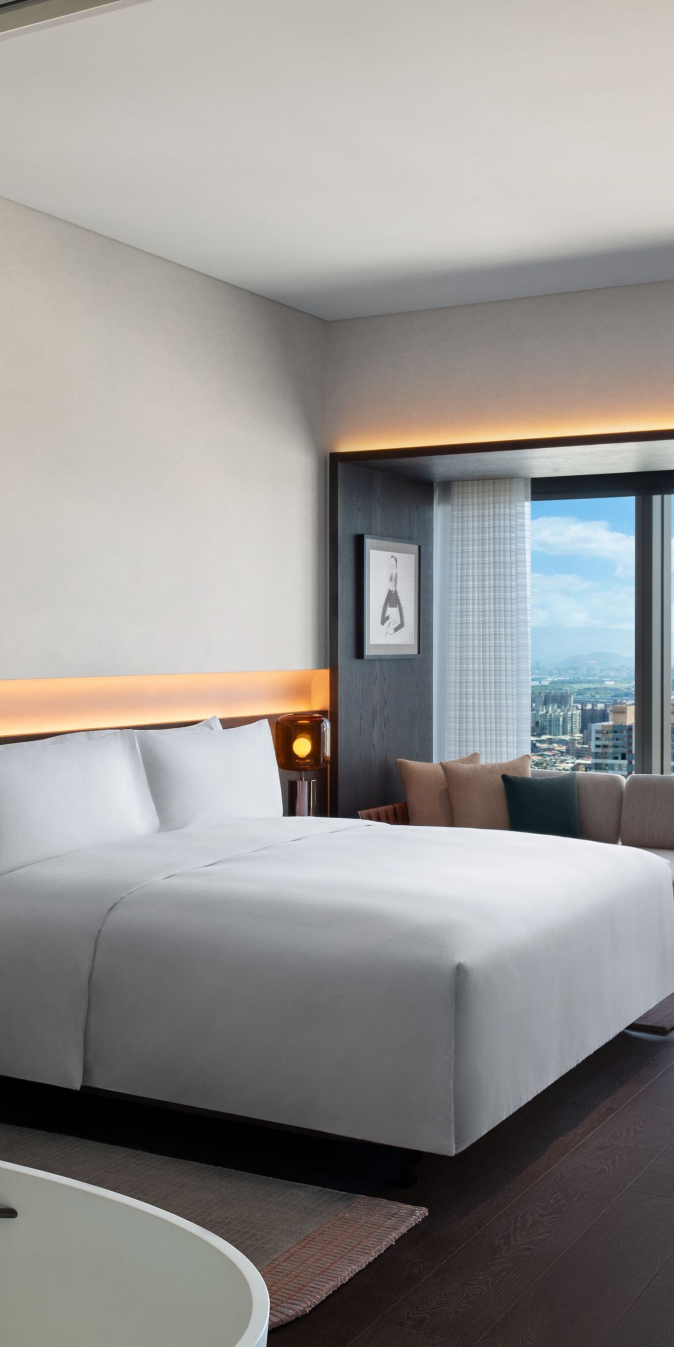 guest room with city view, king bed, desk, sofa