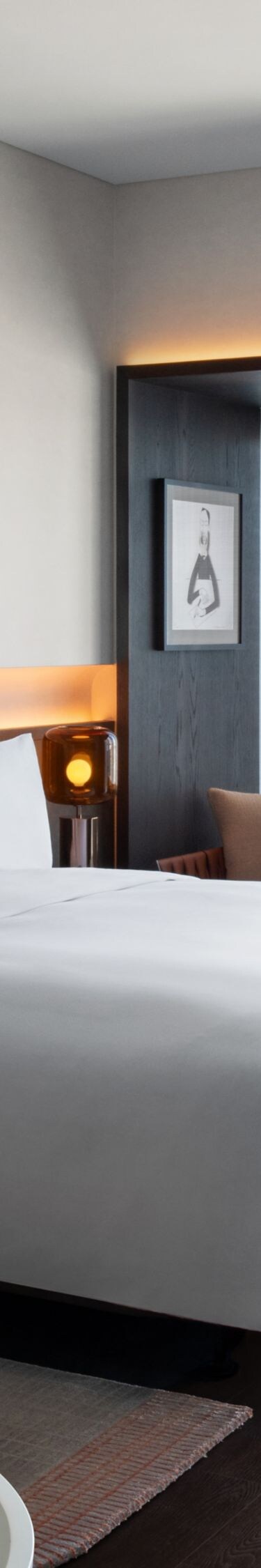 guest room with city view, king bed, desk, sofa