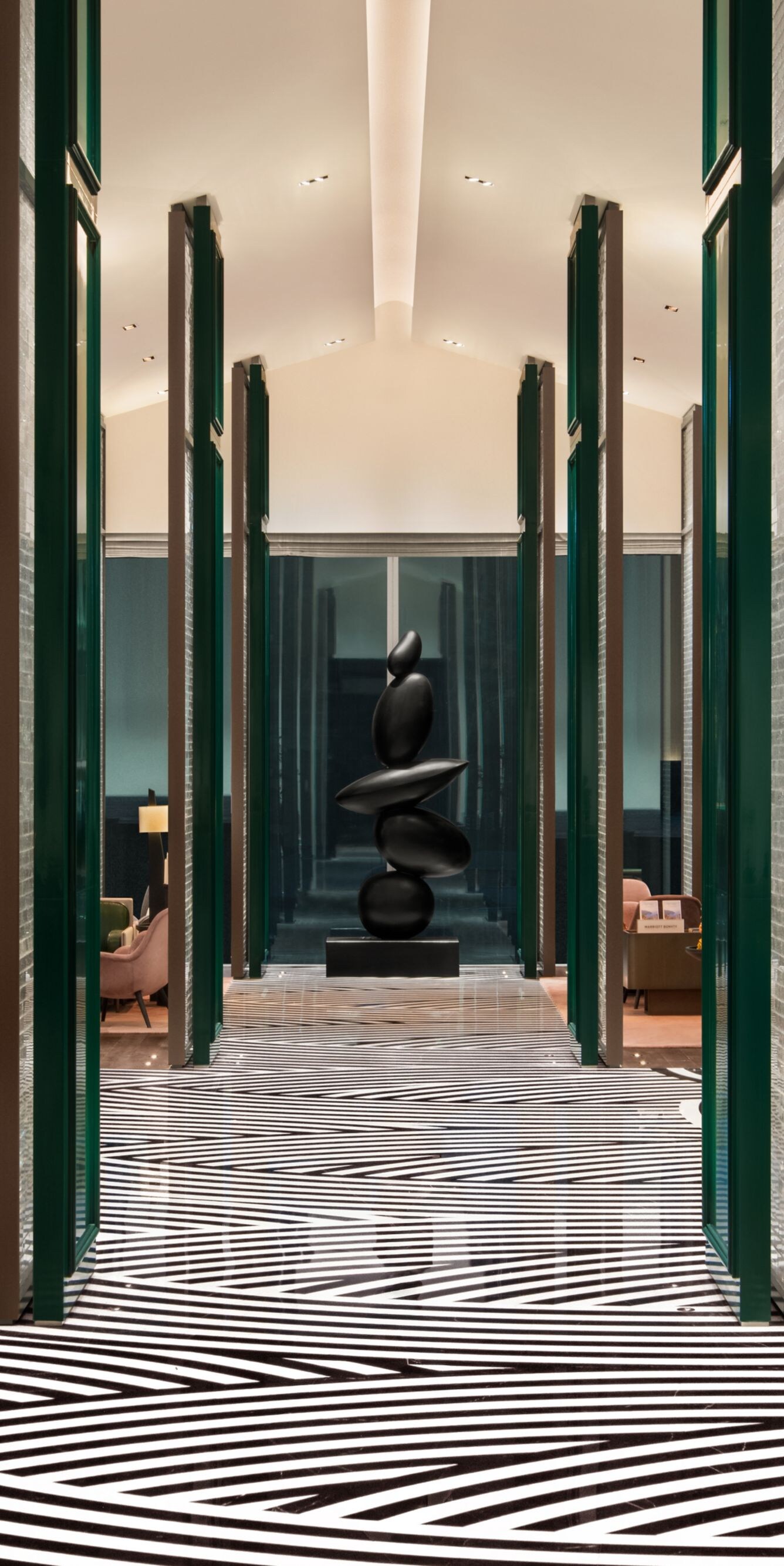 Lobby with tall ceiling, patterned rug