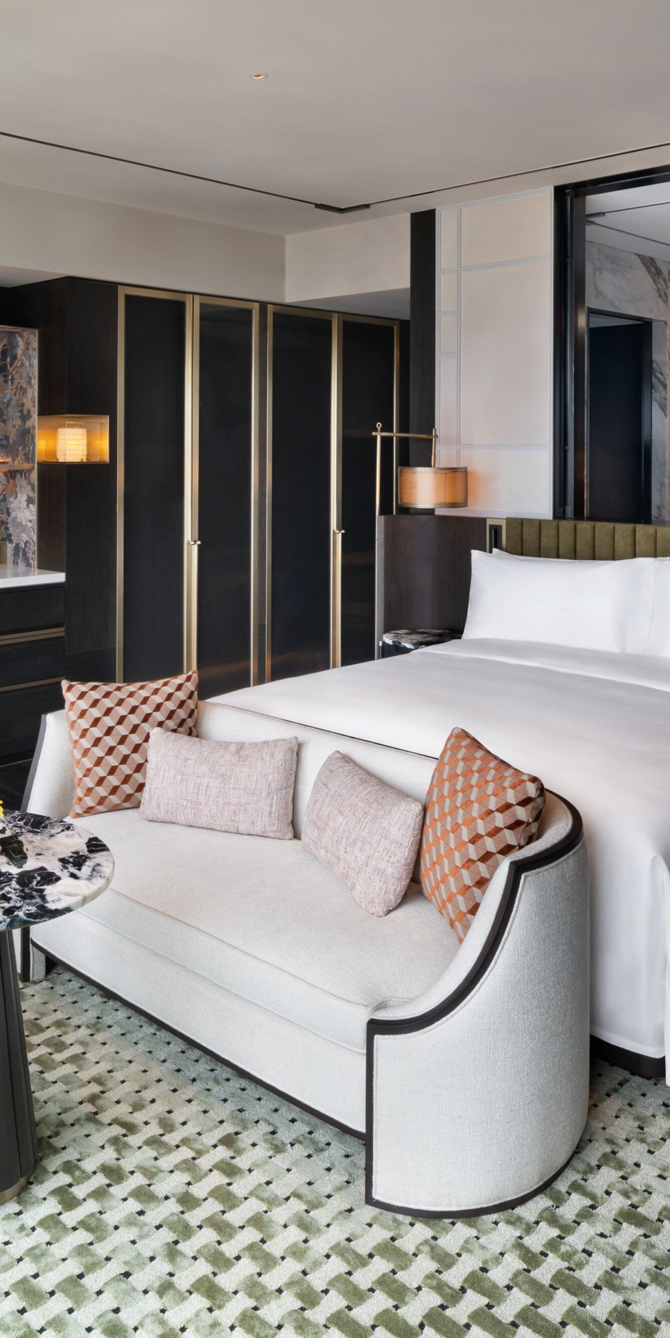 king bed, couch, table, armchair, and lamps