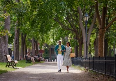 Couple walking through park with gelato