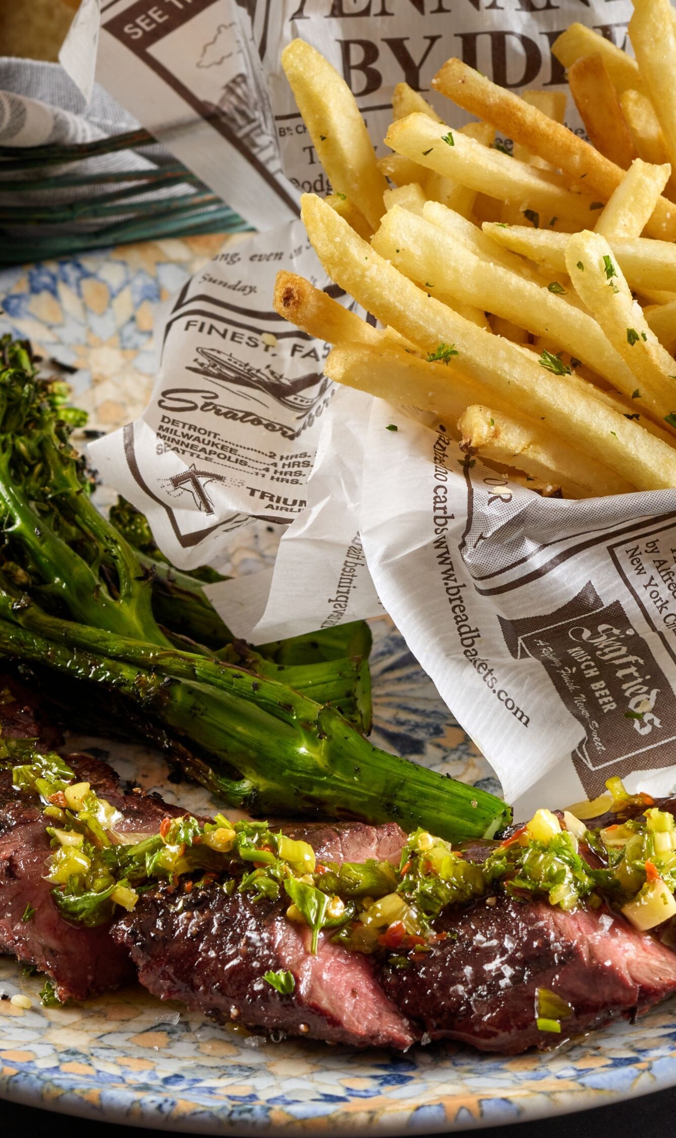 Steak frites and brocolini on a plate 