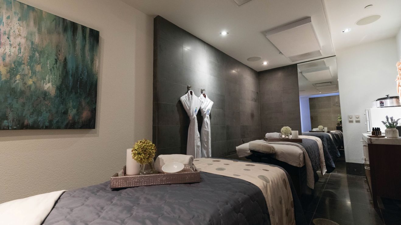 Massage table, tray, robes hanging on wall