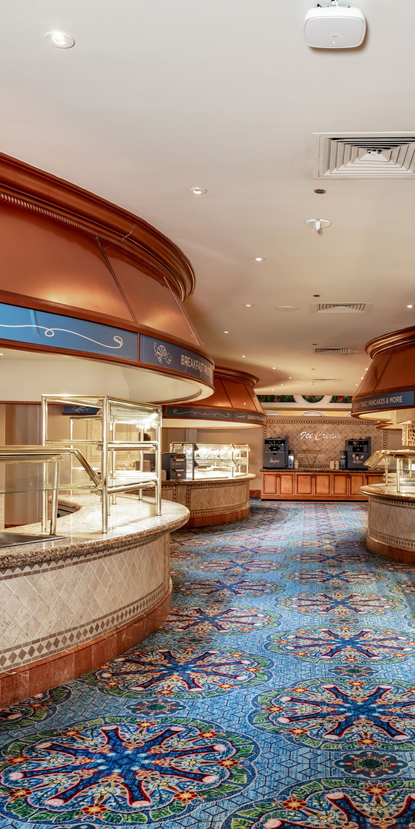 buffet food stations, blue carpet.