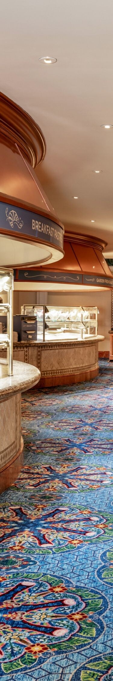 buffet food stations, blue carpet.
