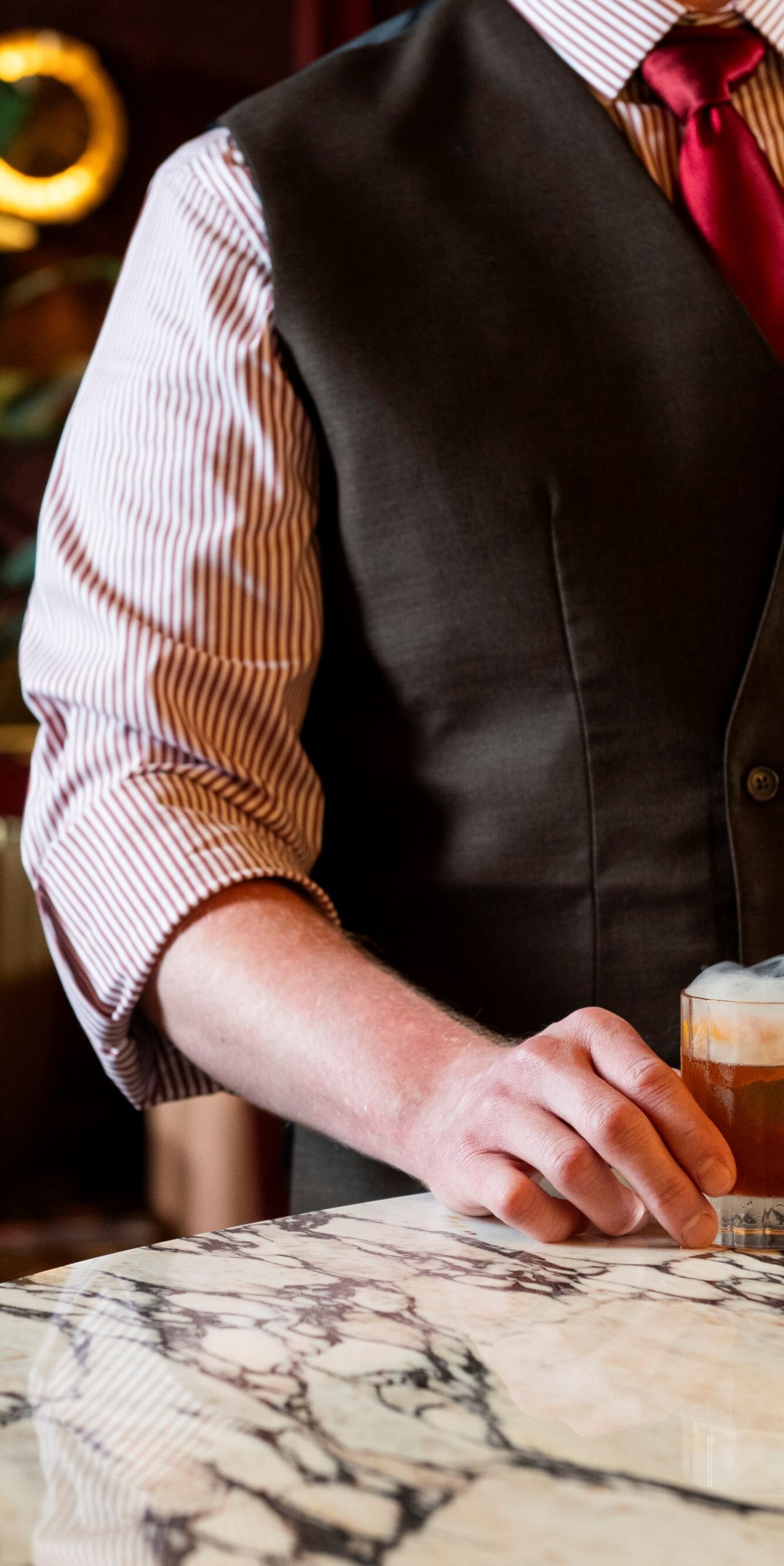 Person holding cocktail glass.