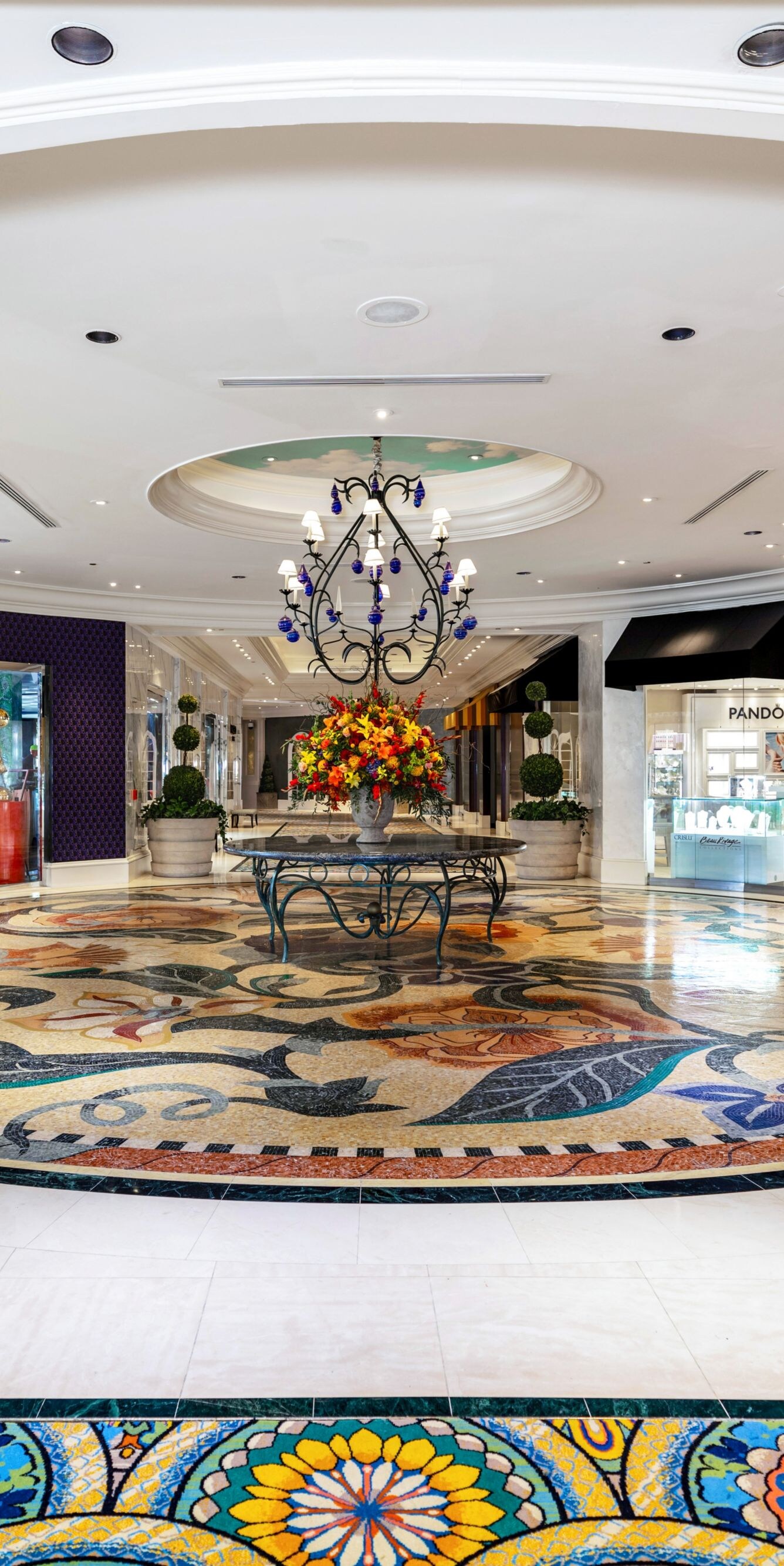 Promenade, retail stores, planters, colored tile.