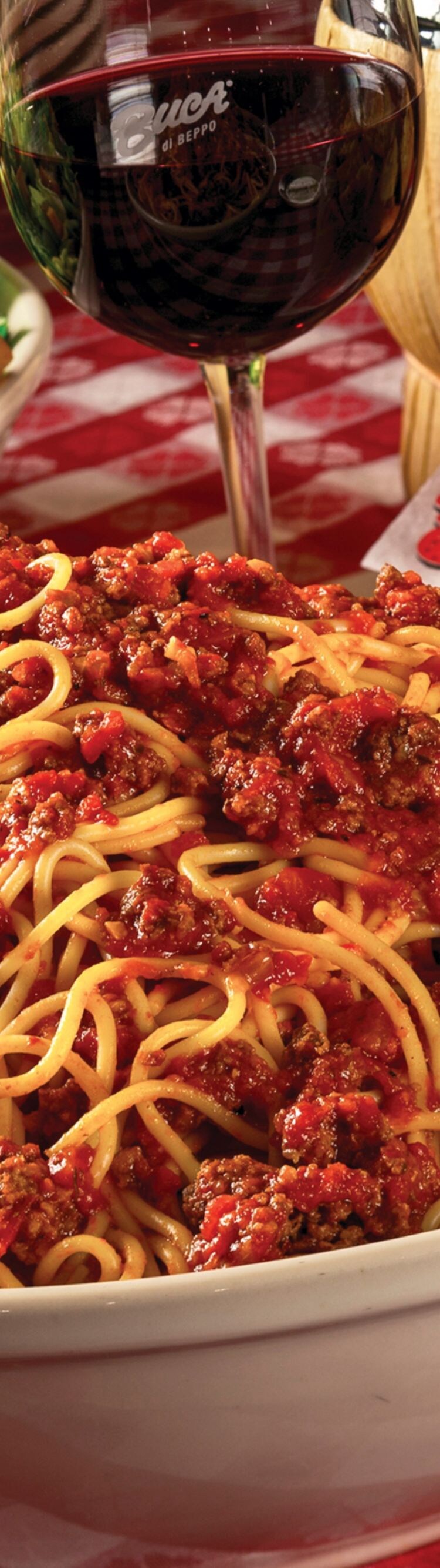 Spaghetti with meat sauce, Caesar salad, bread