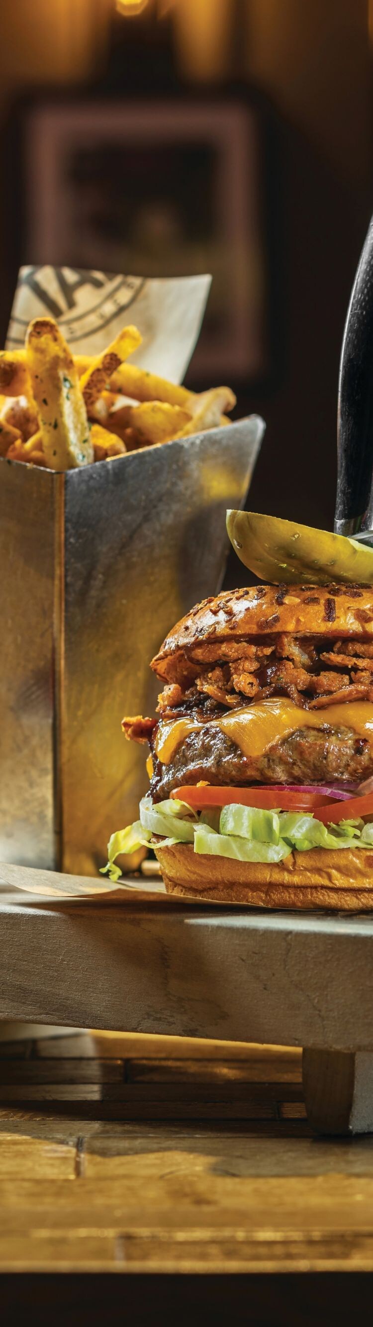 Cheeseburger, fries, beer in a glass mug