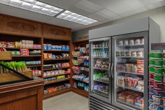 Small store with snacks on shelves and drinks