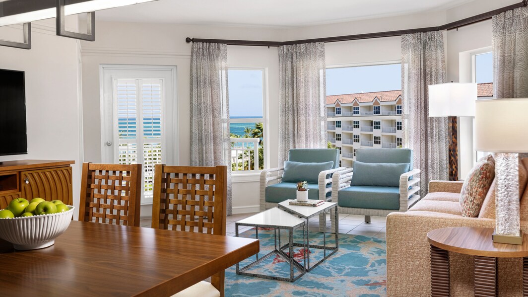 Living, dining area overlooking resort and ocean 