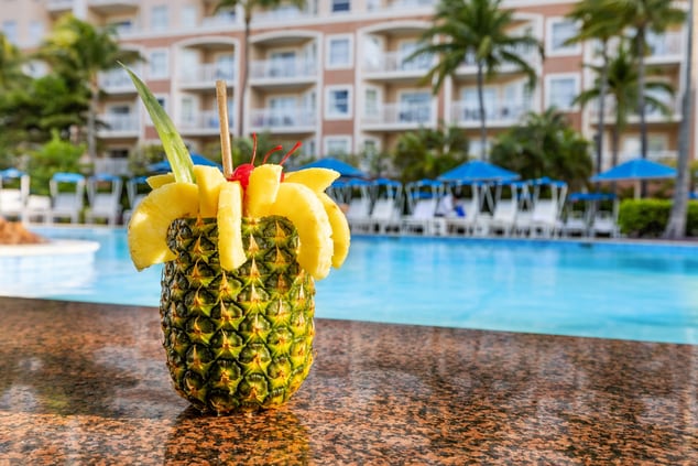 Tropical pineapple drink on bar counter in pool  