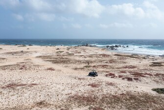 Vista aérea de la playa local con carrito para las dunas