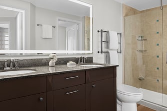 Master bathroom with two sinks and shower stall