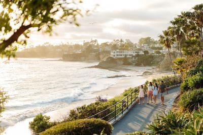 Family walking on beach walkway