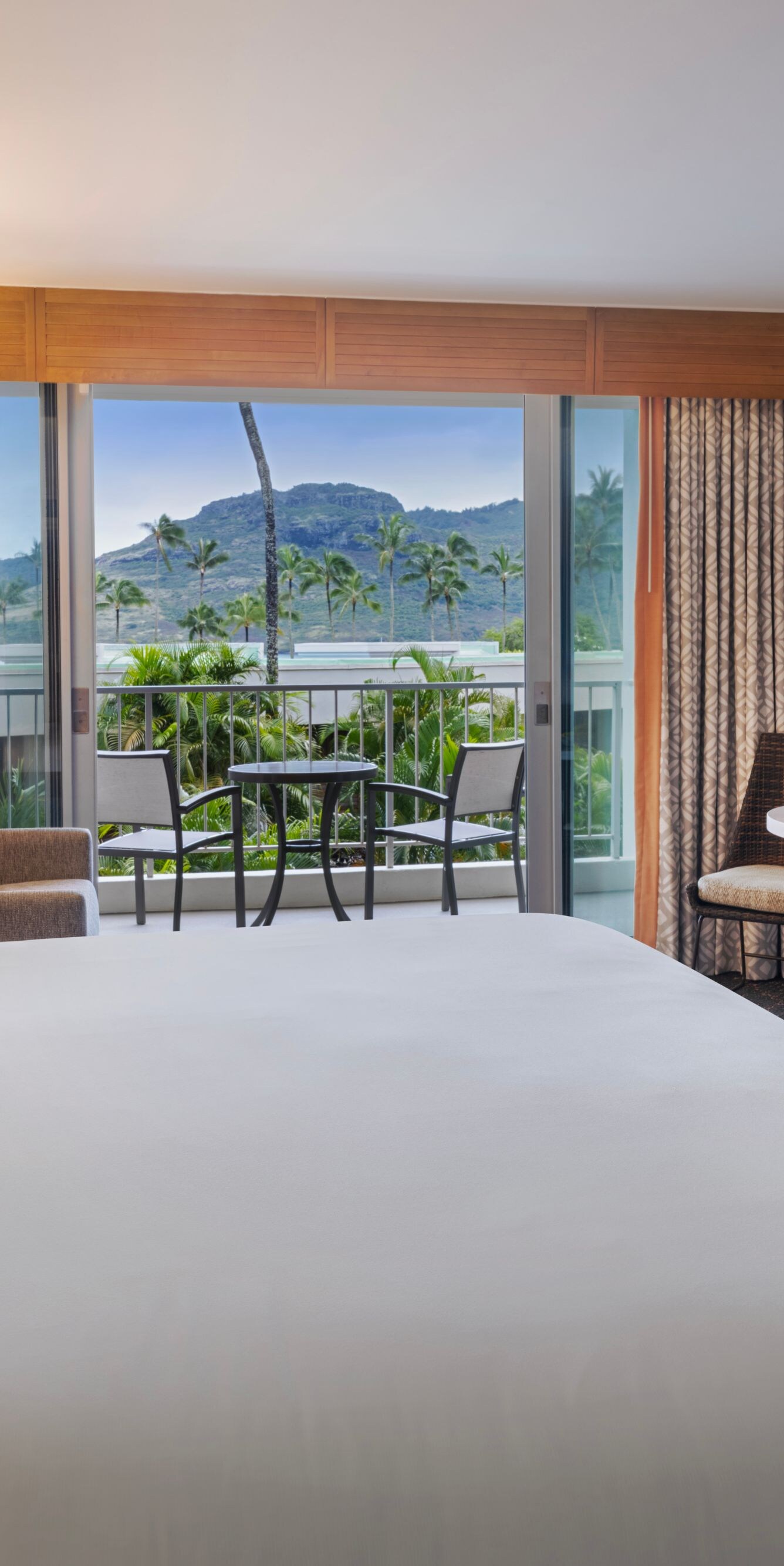 King bed with seating area and balcony