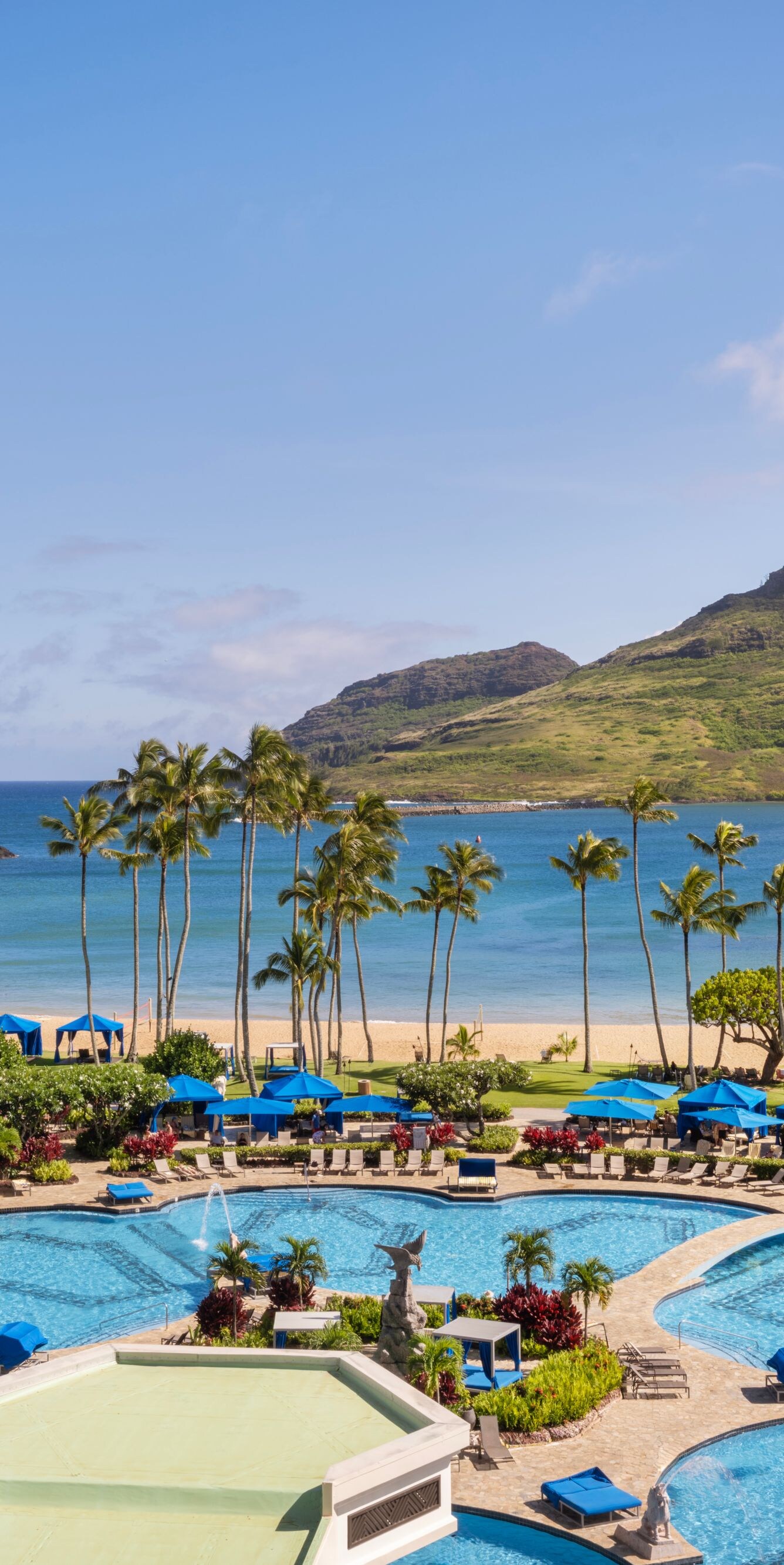 View of resort pool, beach, ocean, and mountains