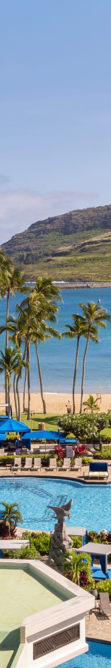 View of resort pool, beach, ocean, and mountains