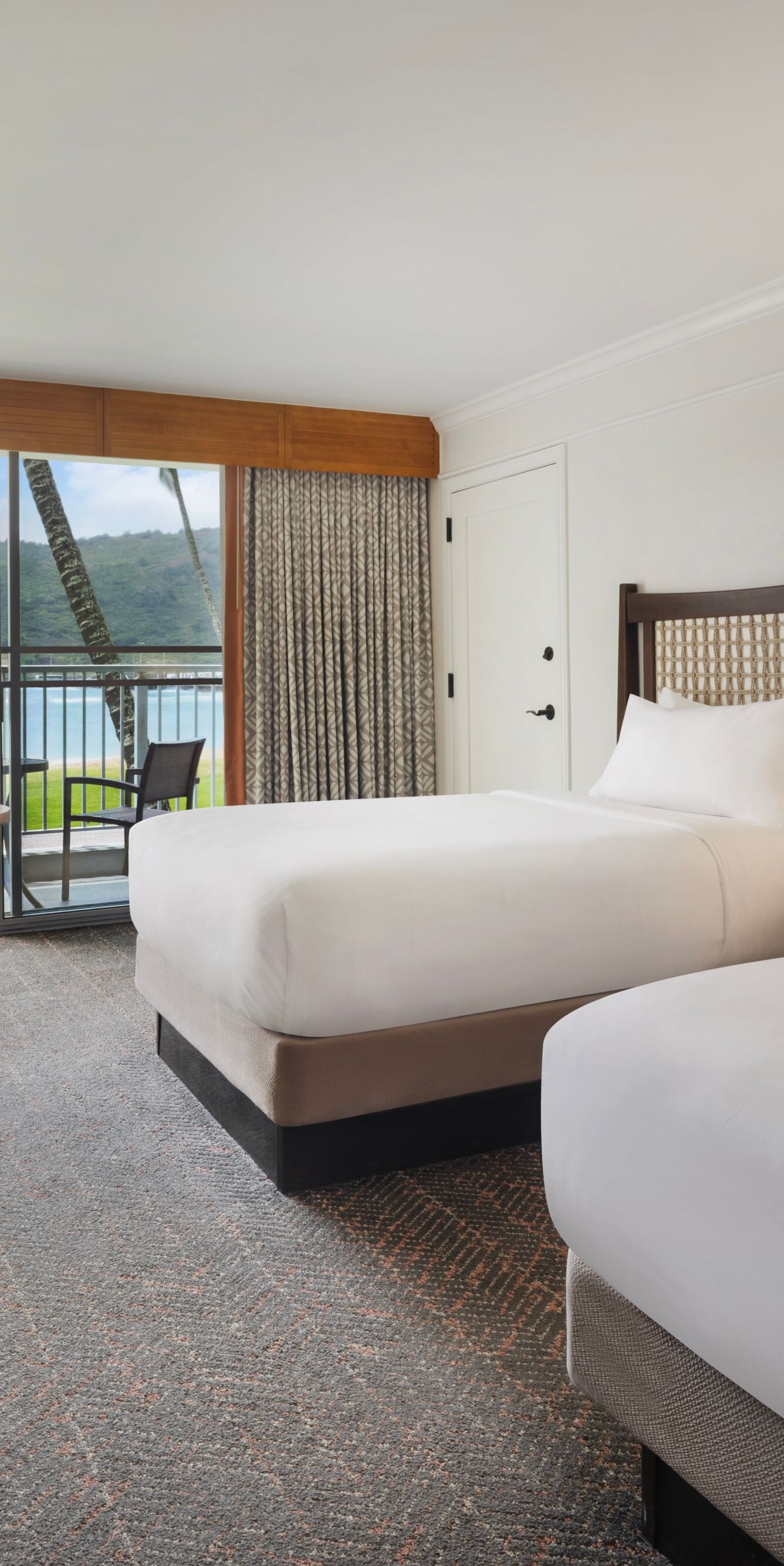 Two double beds with seating area and balcony
