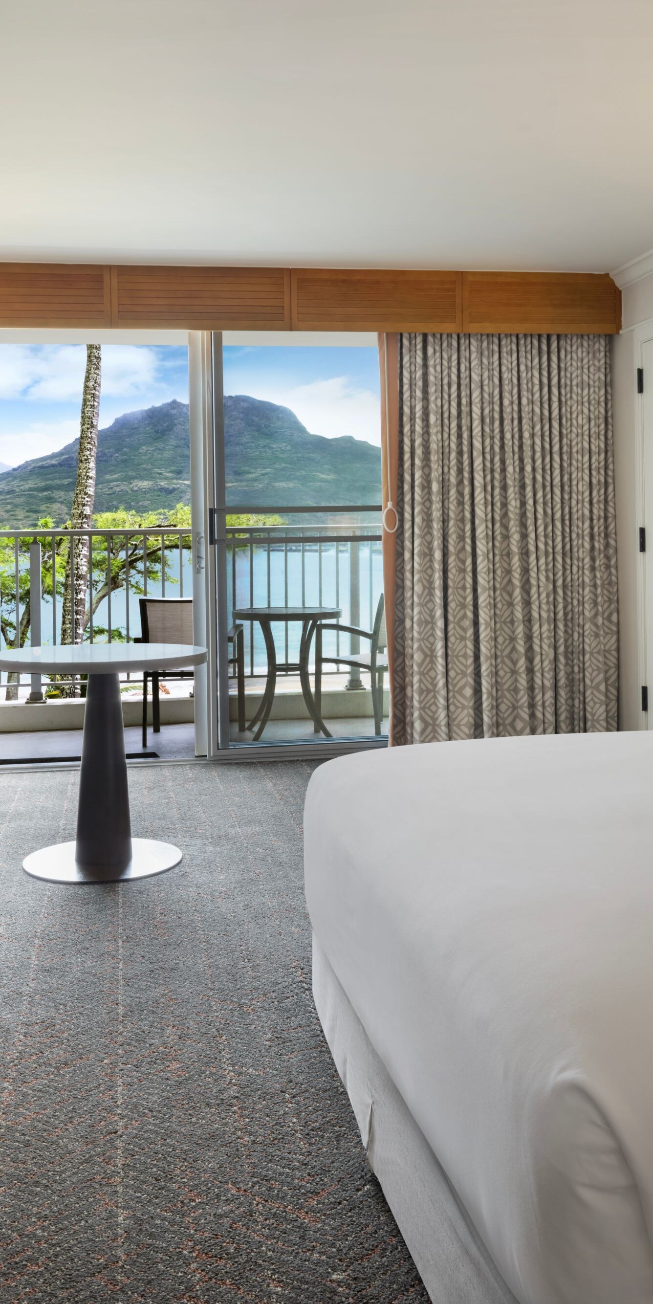 King bed with seating area and balcony
