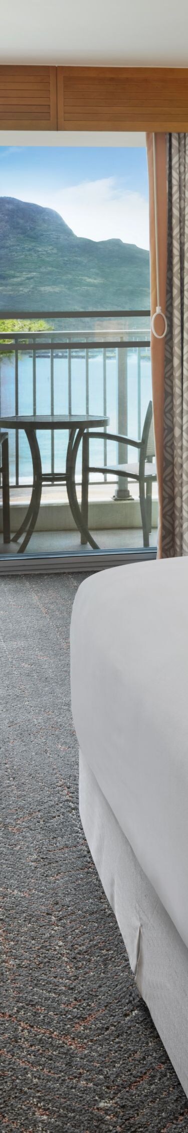 King bed with seating area and balcony