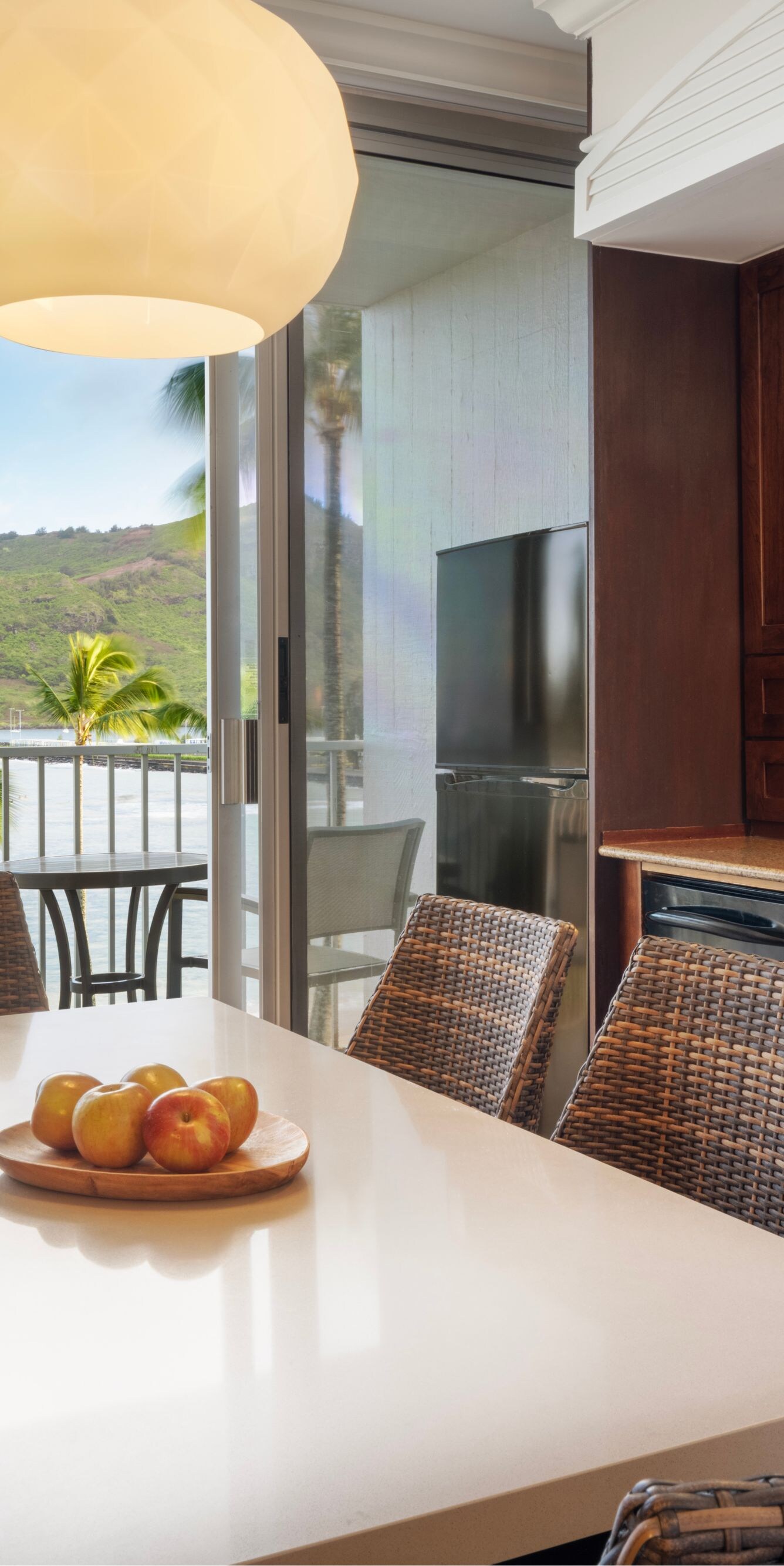 Dining table and balcony with view of beach
