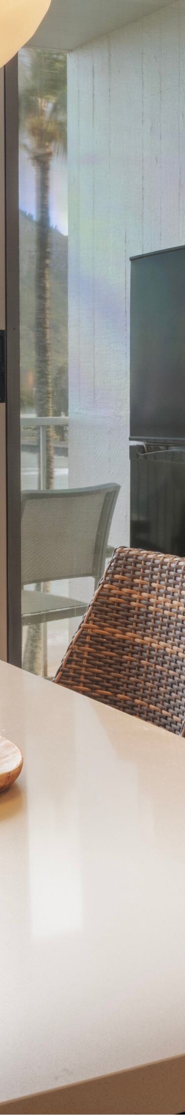 Dining table and balcony with view of beach
