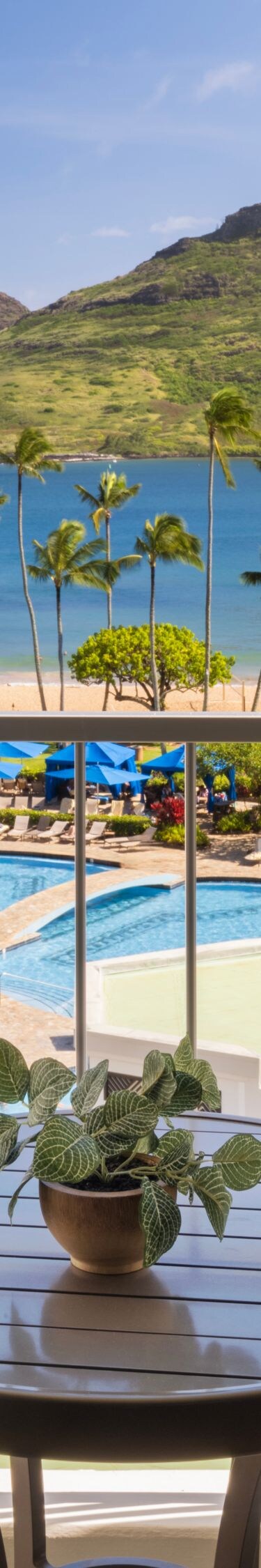 Beachfront balcony with tables, chairs