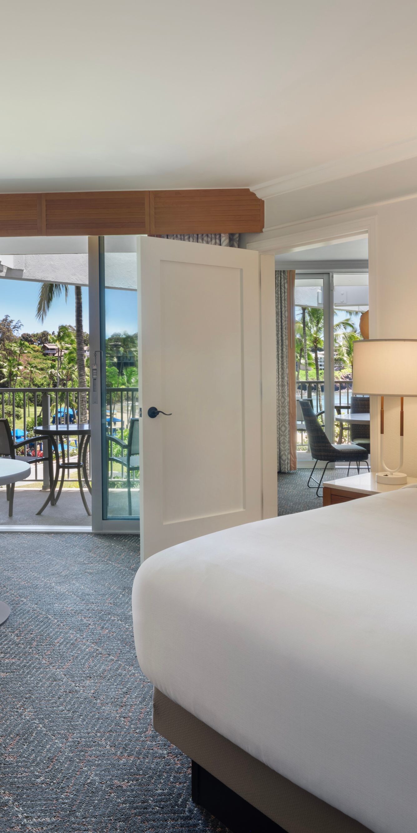 King bed with seating area and furnished balcony