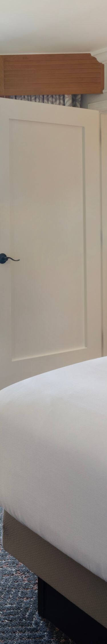 King bed with seating area and furnished balcony