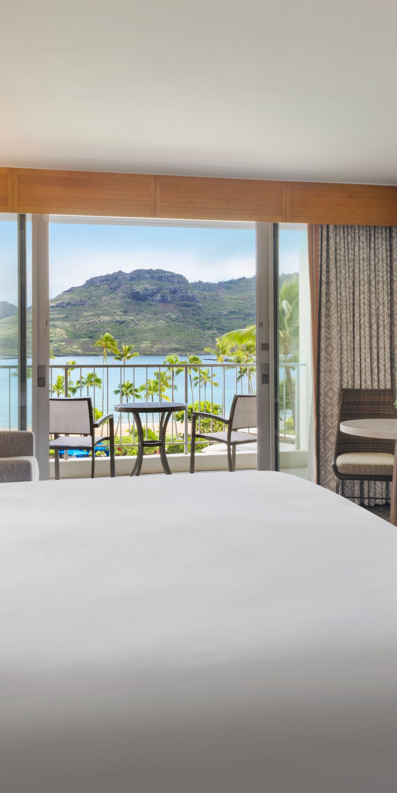 King bed and seating area with beachfront balcony