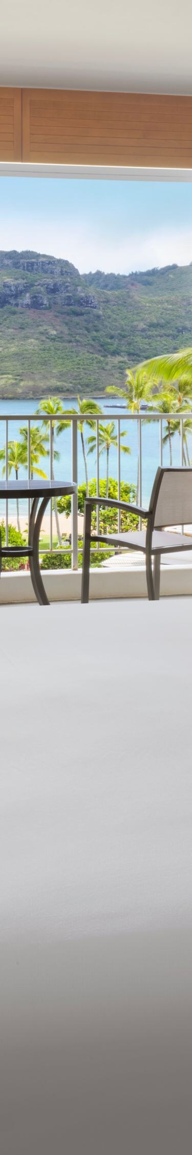 King bed and seating area with beachfront balcony