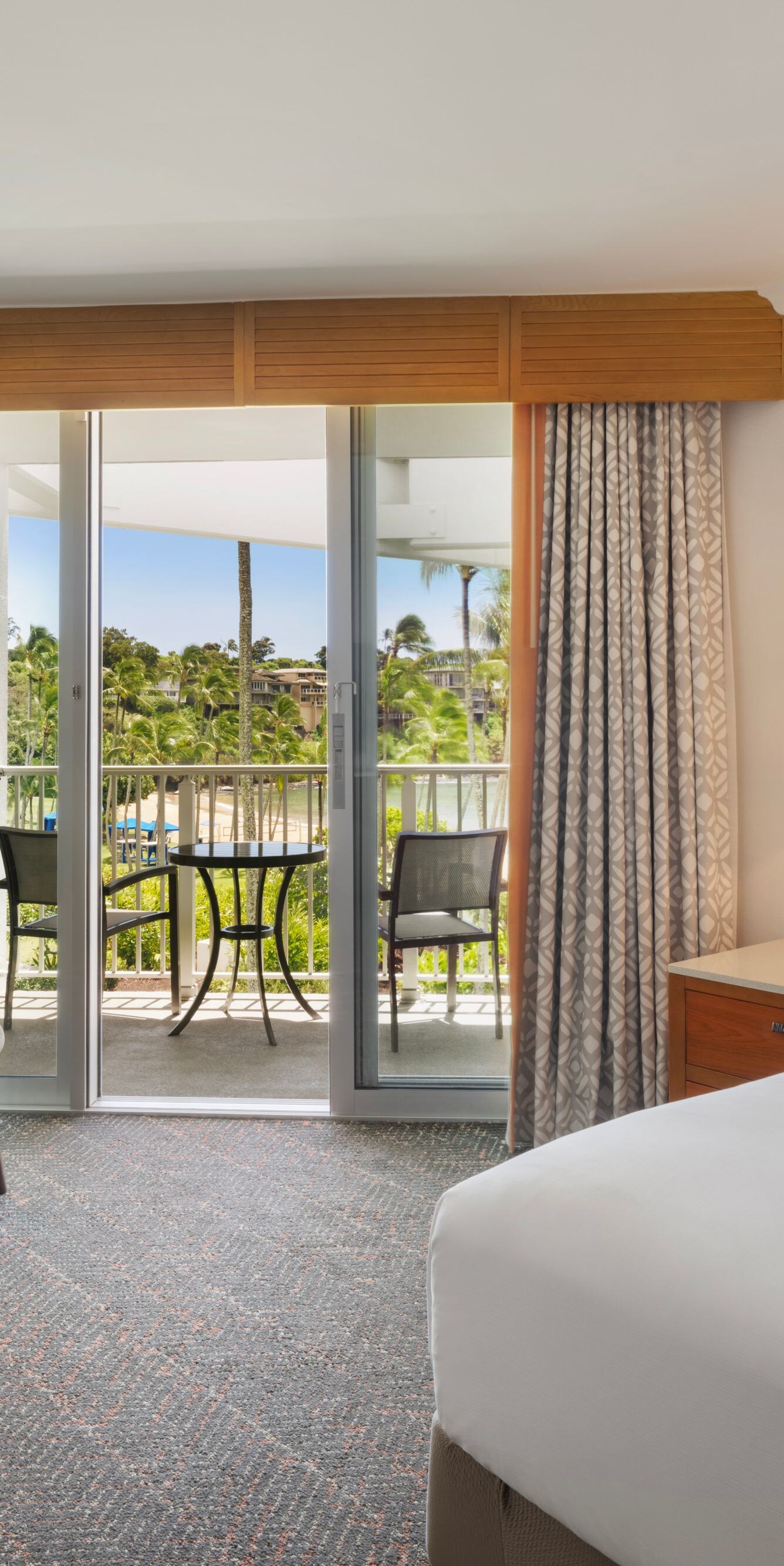 King bed with small table and furnished balcony