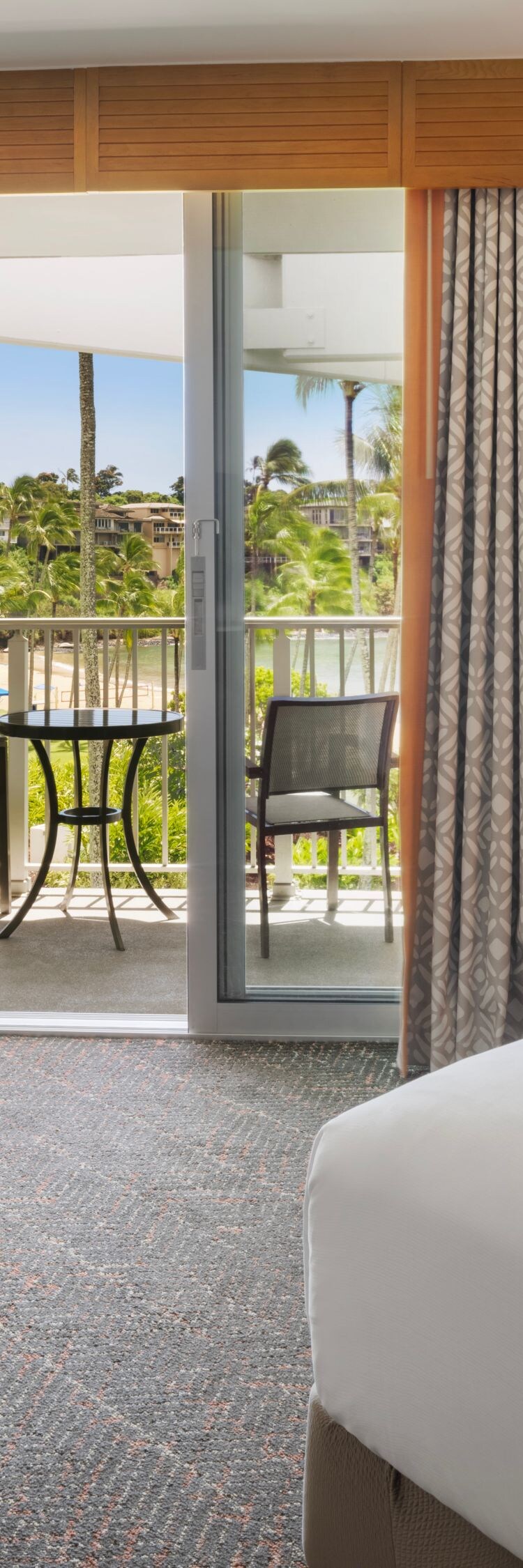 King bed with small table and furnished balcony
