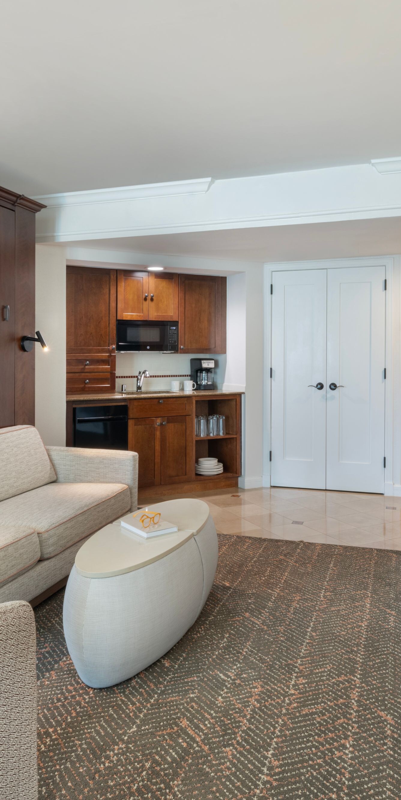 Living area with sofa, TV, microwave, coffee maker