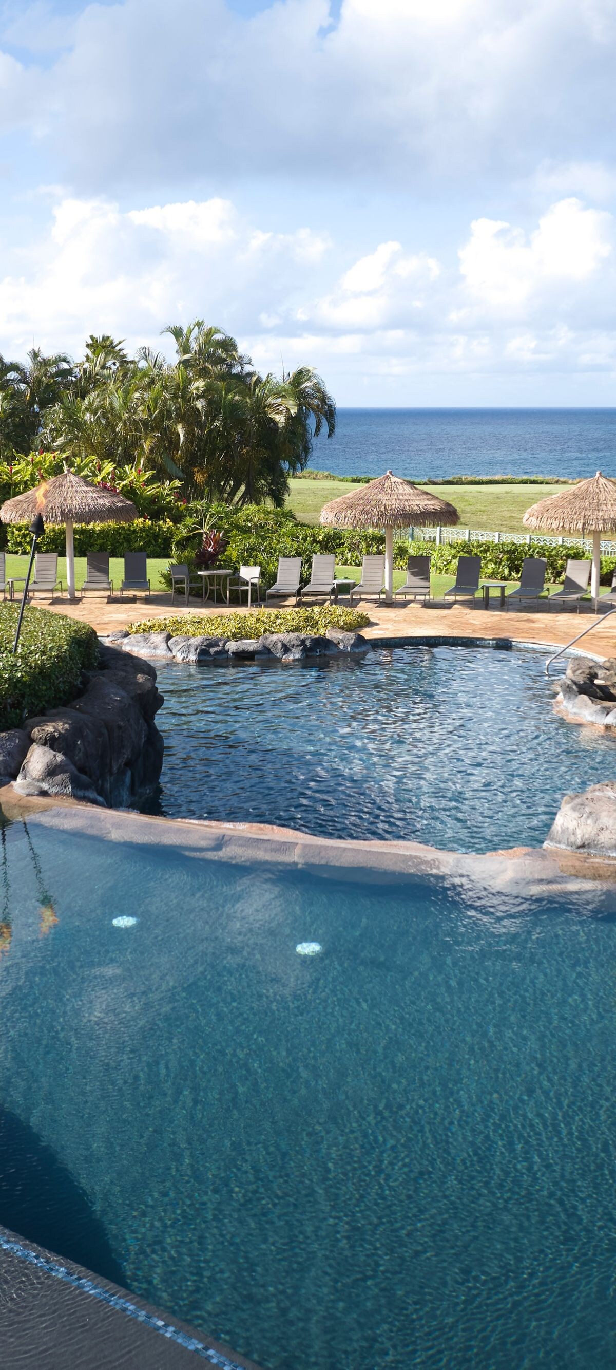 Lihue resort pool with slide and ocean views