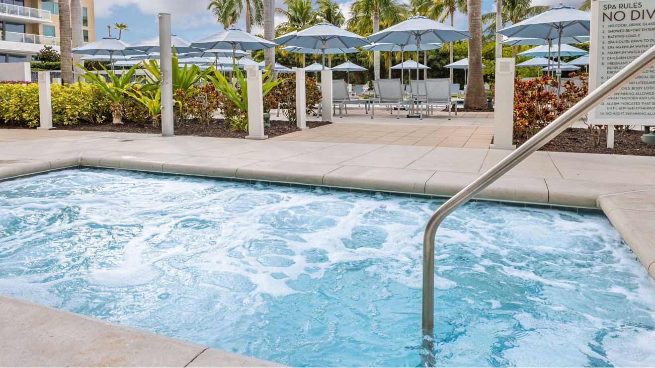 Whirlpool next to pool with loungers