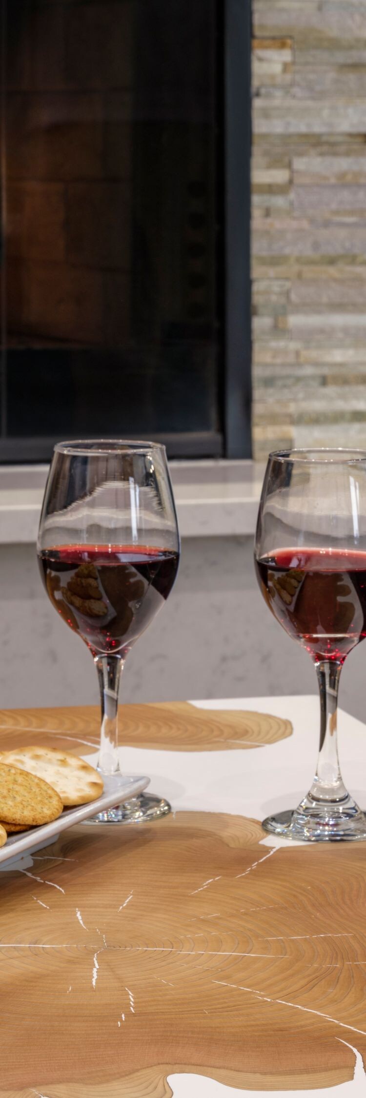 Wine and light snacks on table near by fireplace