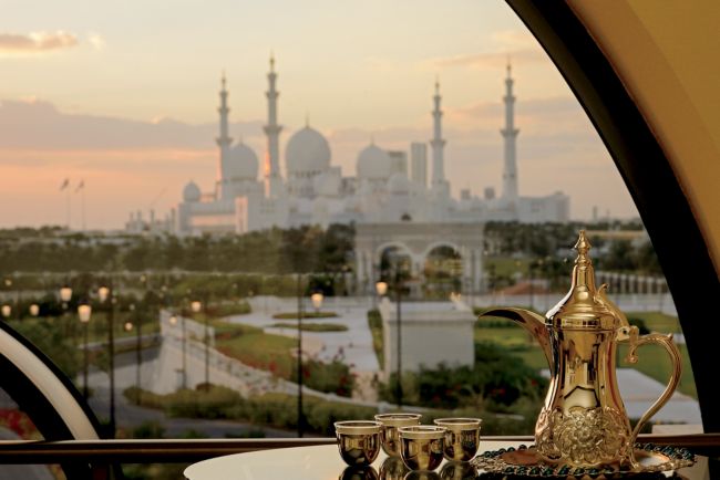 Traditional tea serving in a suite with sweeping views of Sheikh Zayed Grand Mosque