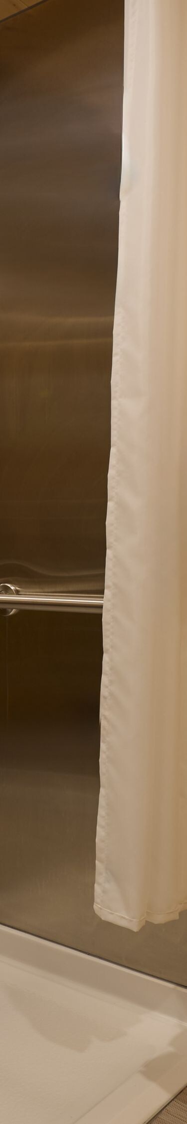 Accessible roll-in shower with grab bars