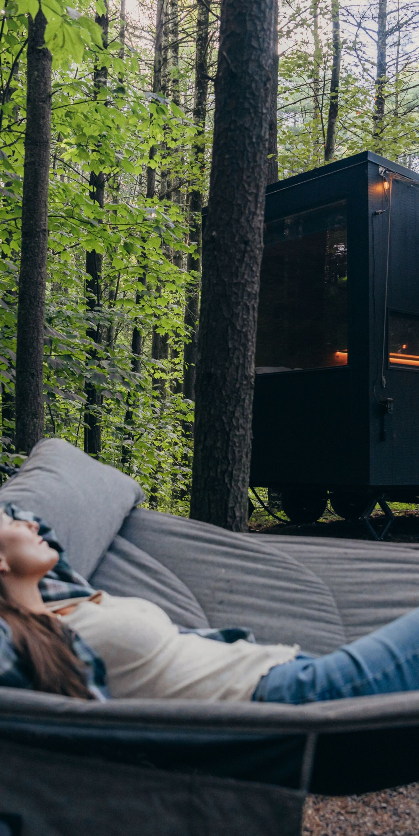 Woman on hammock outside cabin
