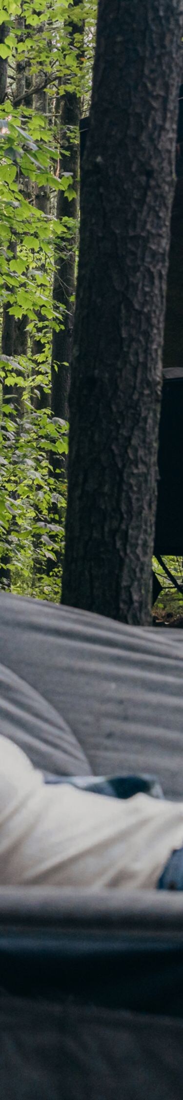 Woman on hammock outside cabin