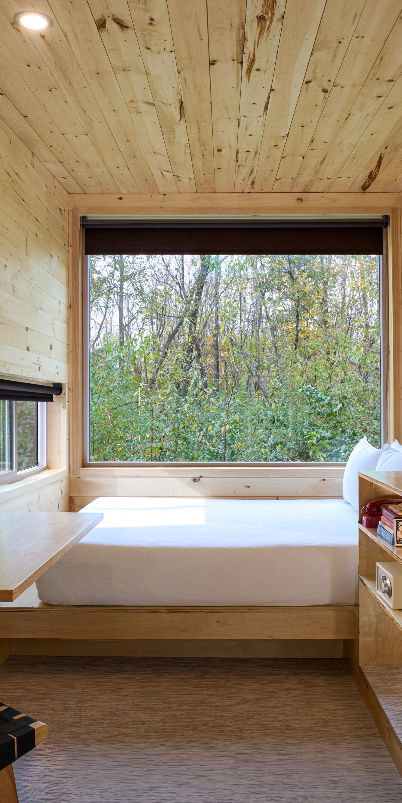 Cabin with kitchenette, dining table, bed, window