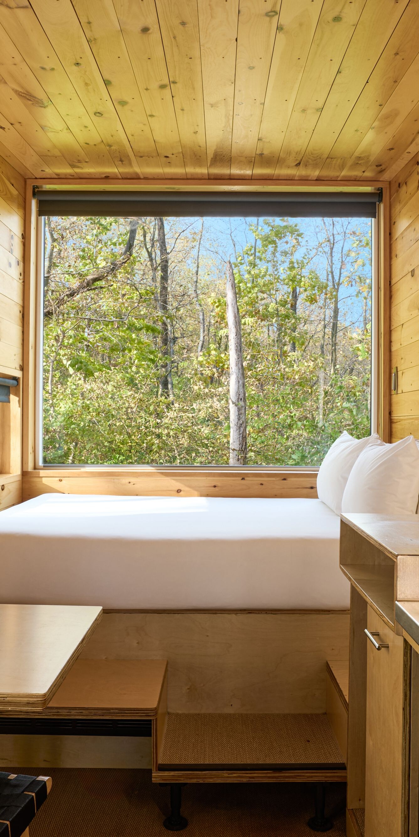 Cabin with kitchenette, dining table, bed, window