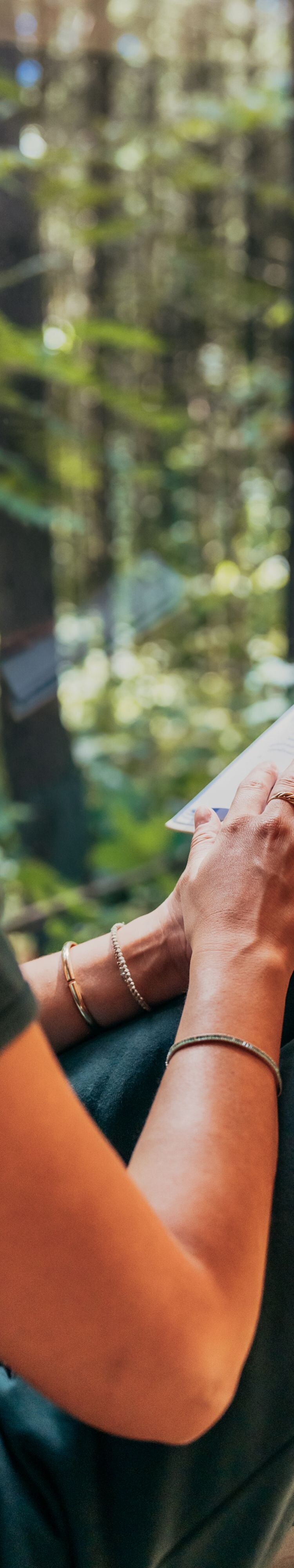 Woman looking out cabin window reading