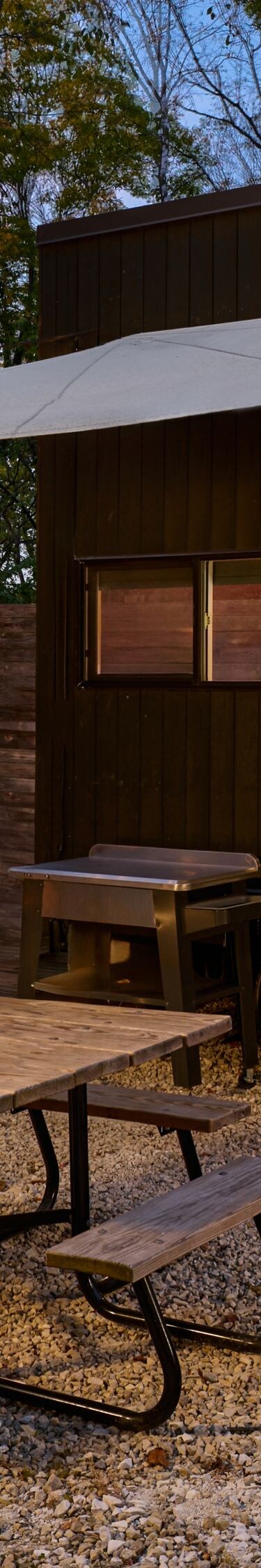 cabin exterior with fire pit and picnic table